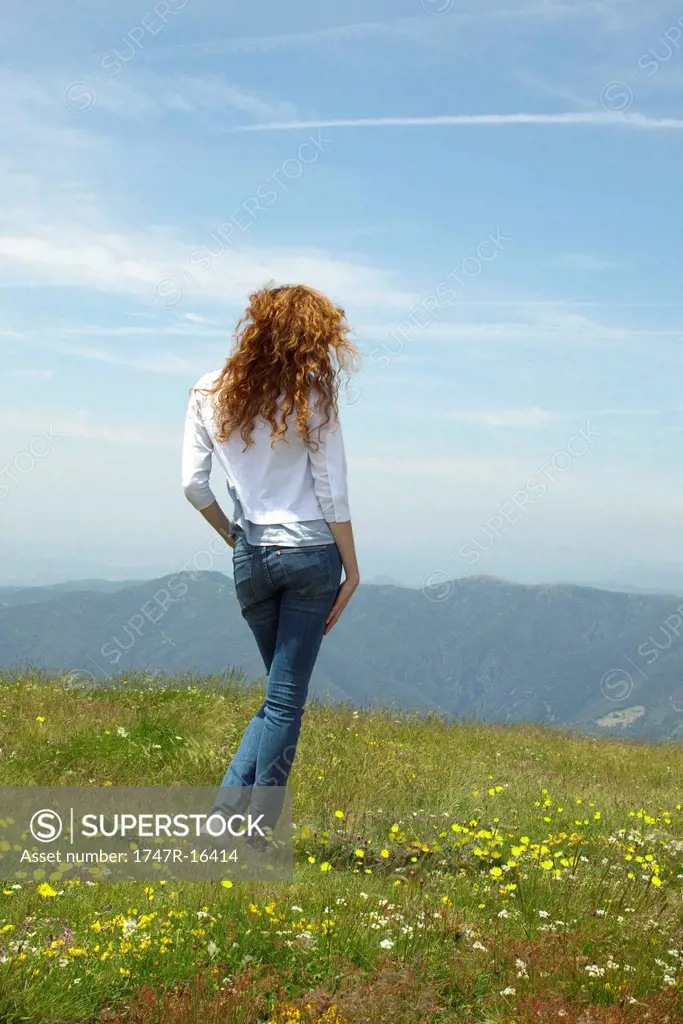 Woman walking through meadow