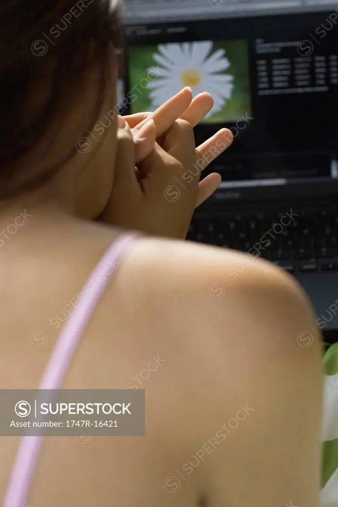 Woman using laptop computer, rear view