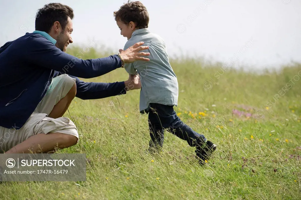Father and son playing together outdoors