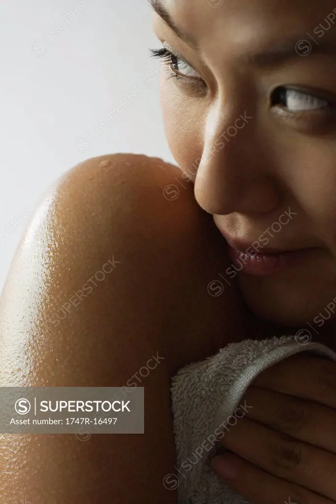Young woman with wet shoulder, cropped