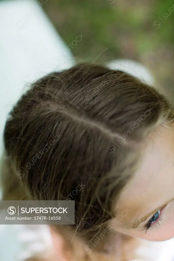Woman with hair parted, directly above