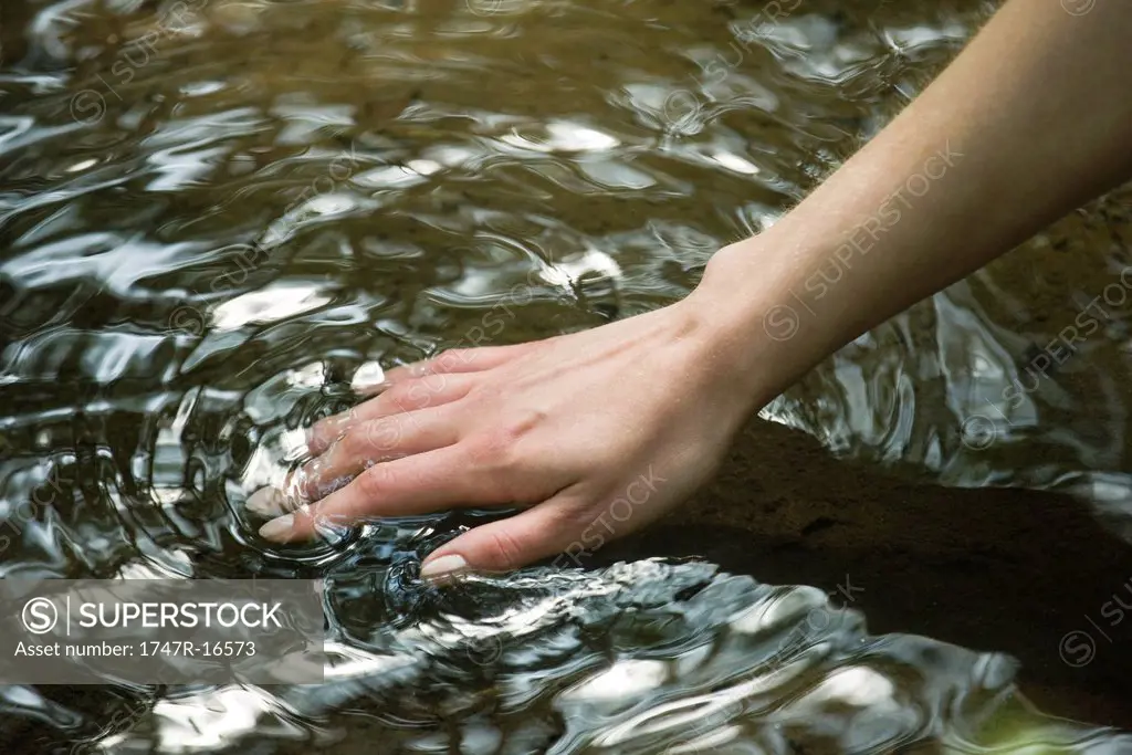 Woman´s hand feeling water