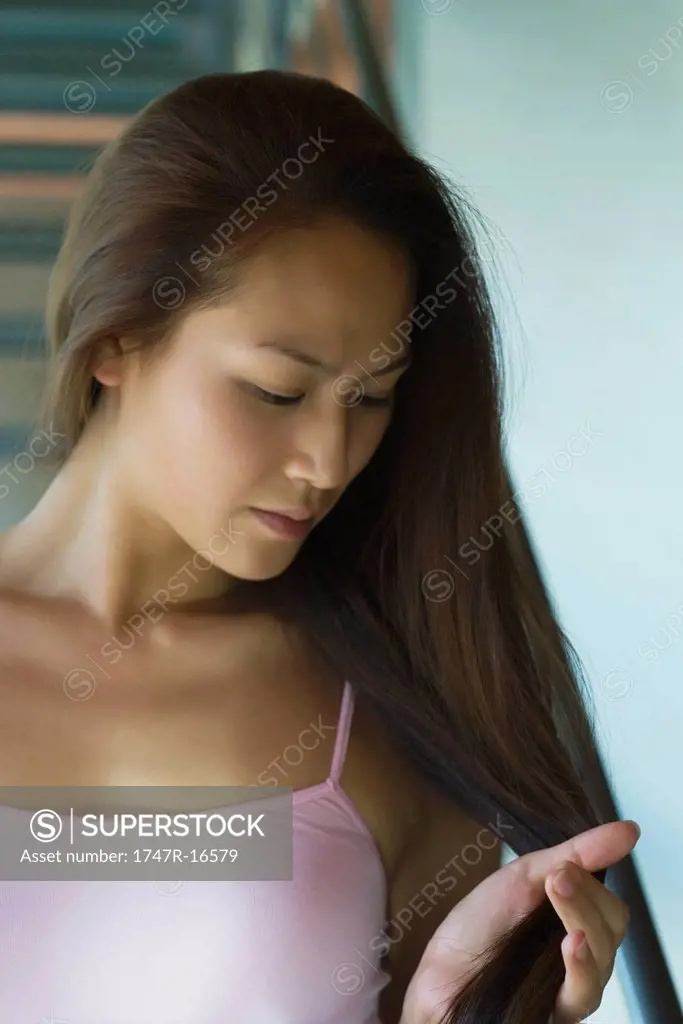 Young woman touching hair