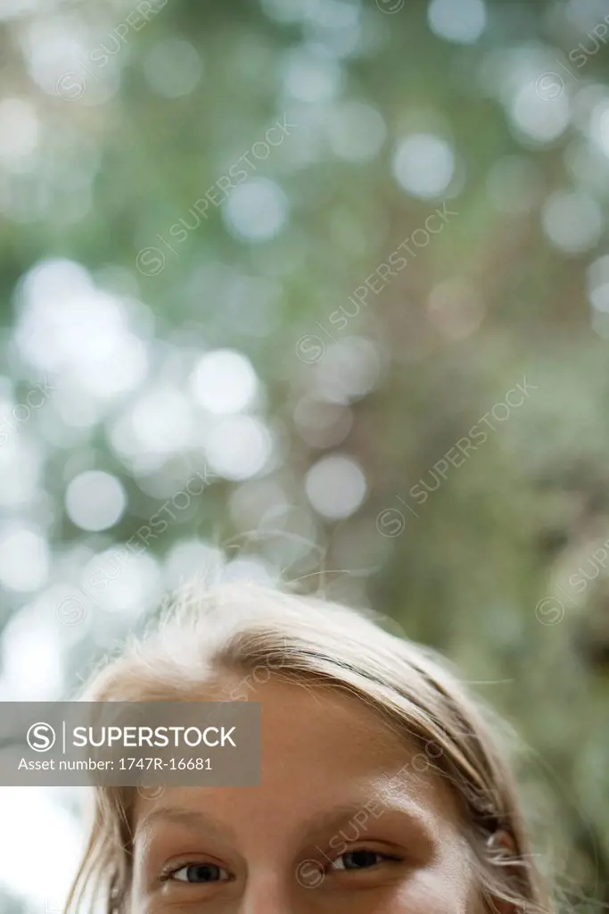 Woman looking down at camera, cropped