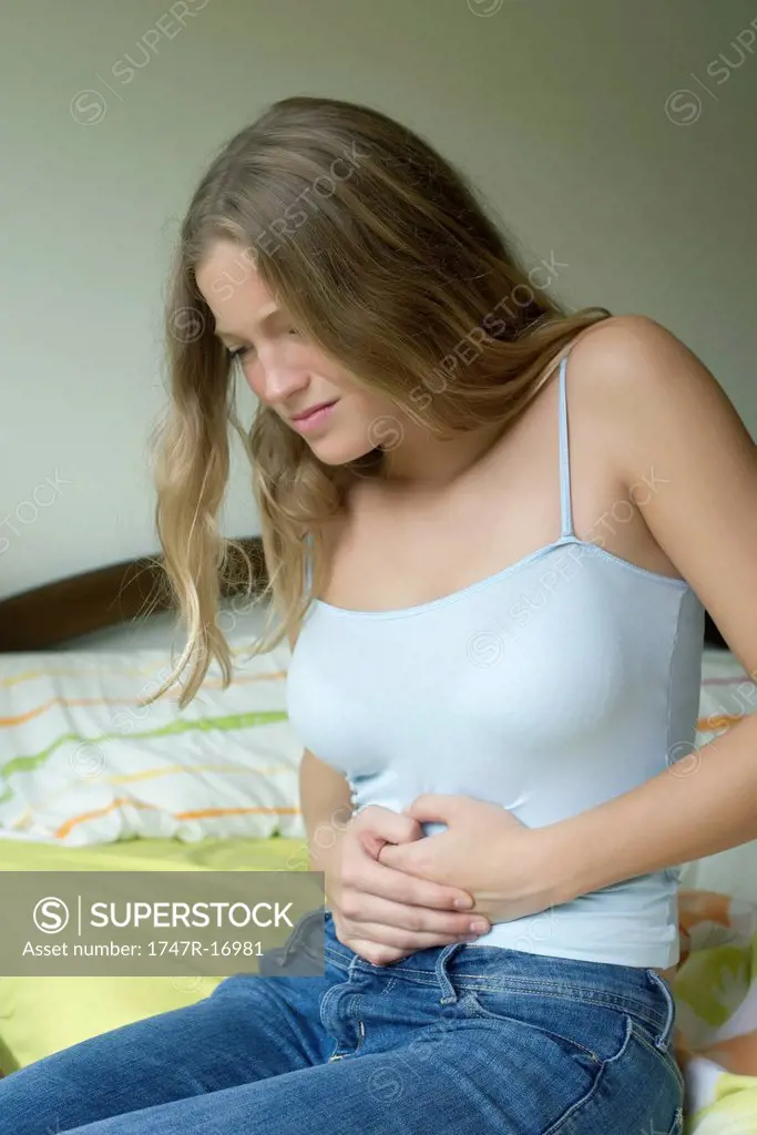Young woman experiencing abdominal pain