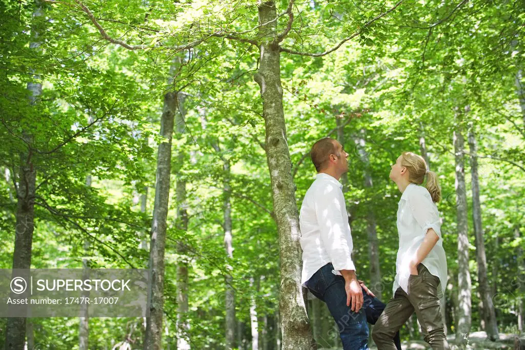 Couple standing in woods