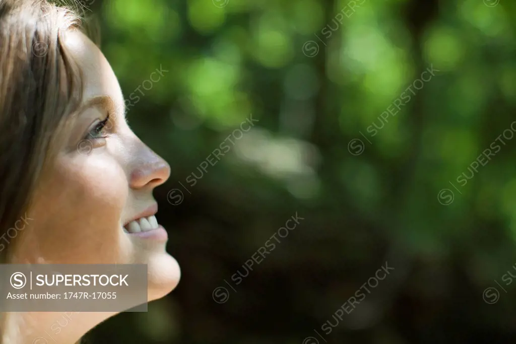Young woman in nature, side view