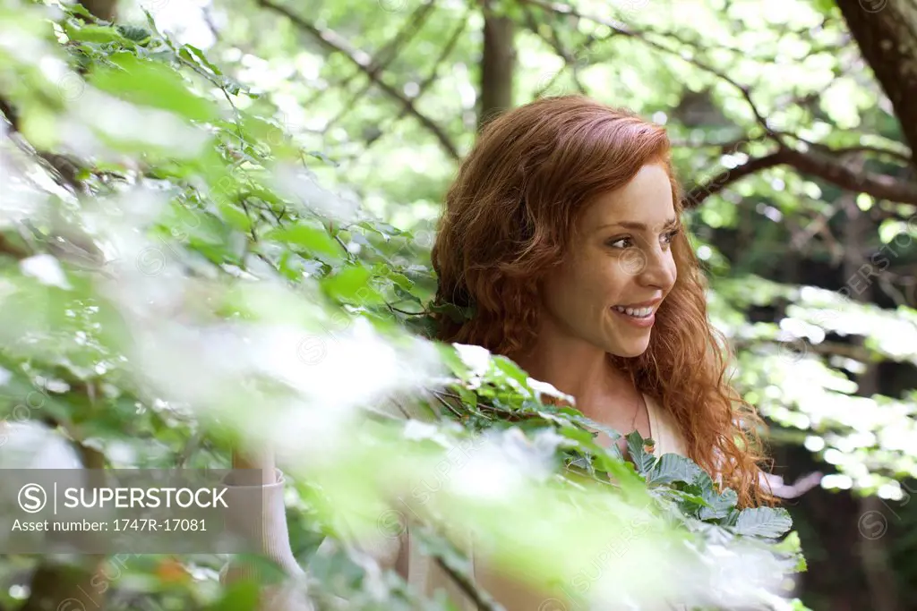 Woman amongst foliage, portrait