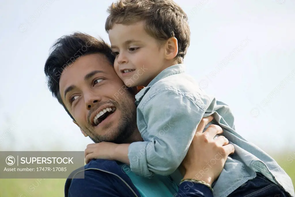 Father and young son embracing outdoors