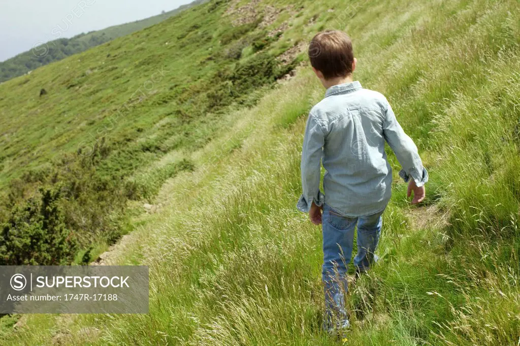 Boy exploring hillside
