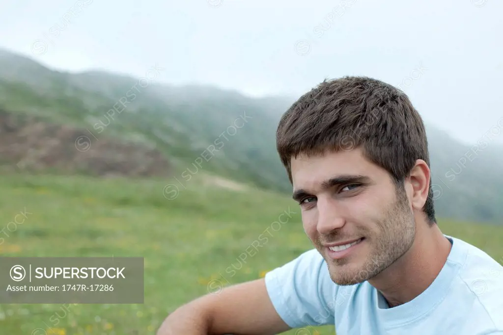 Man in nature, mountains in background, portrait