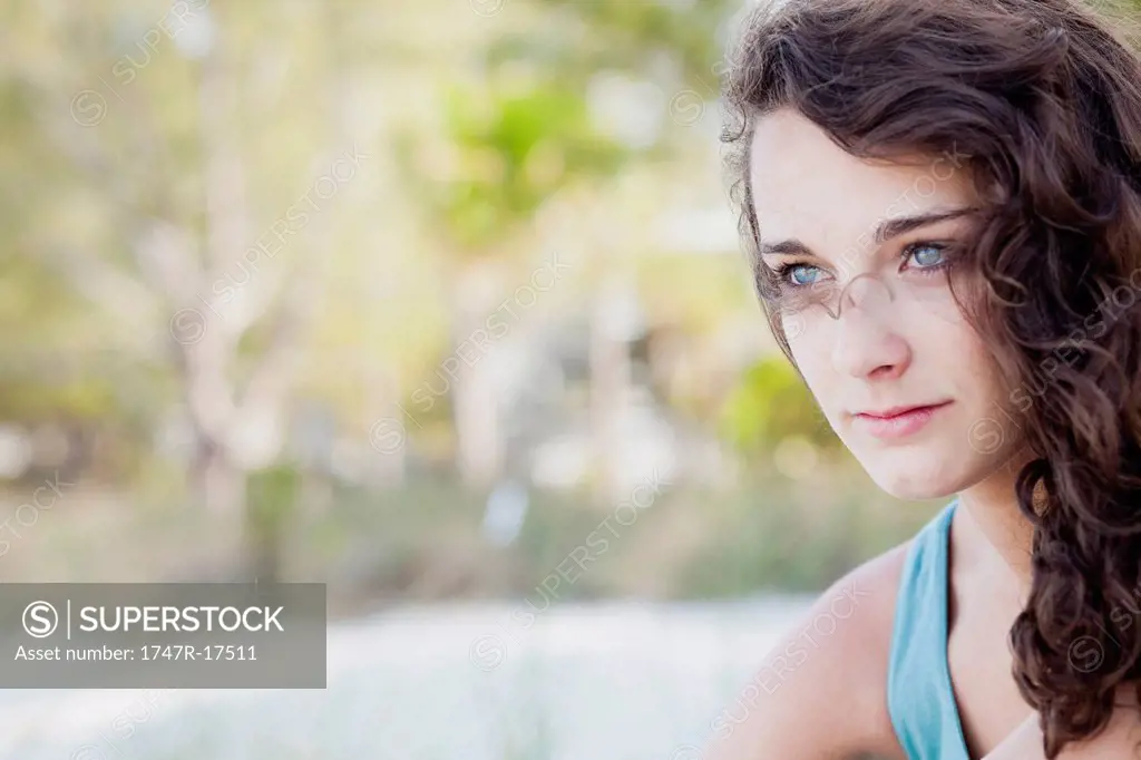 Teenage girl looking away in thought, portrait