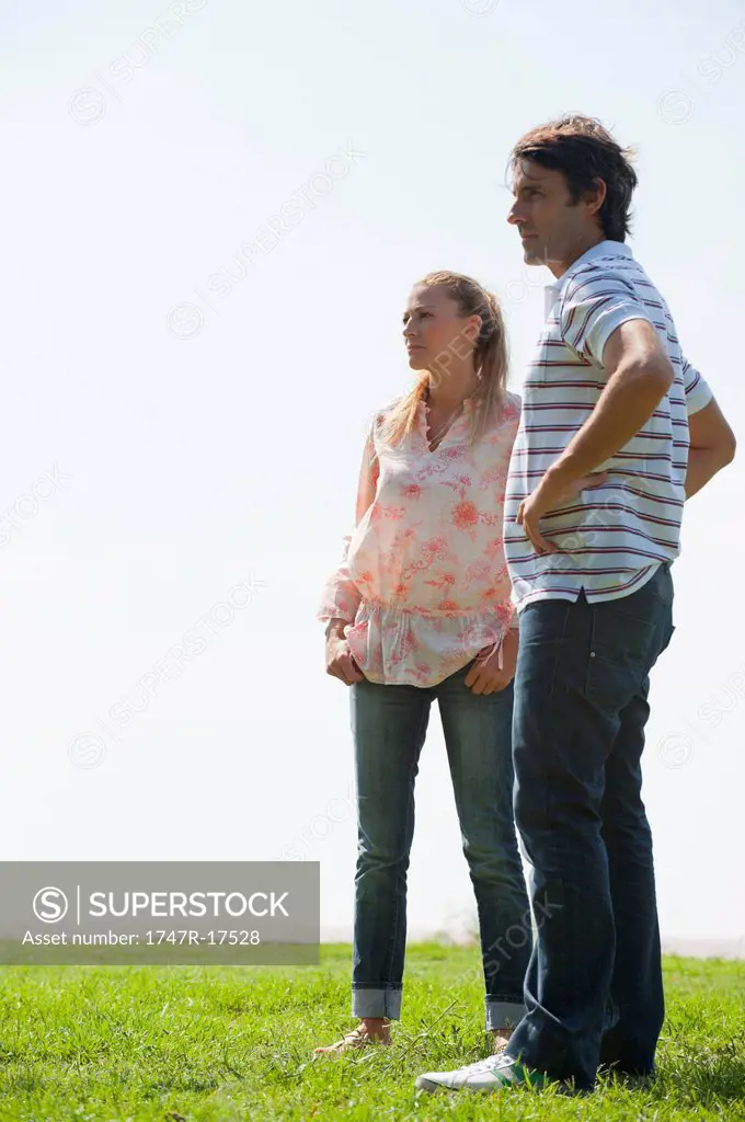 Mature couple standing on meadow