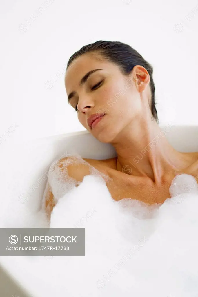 Mid_adult woman relaxing in bubble bath