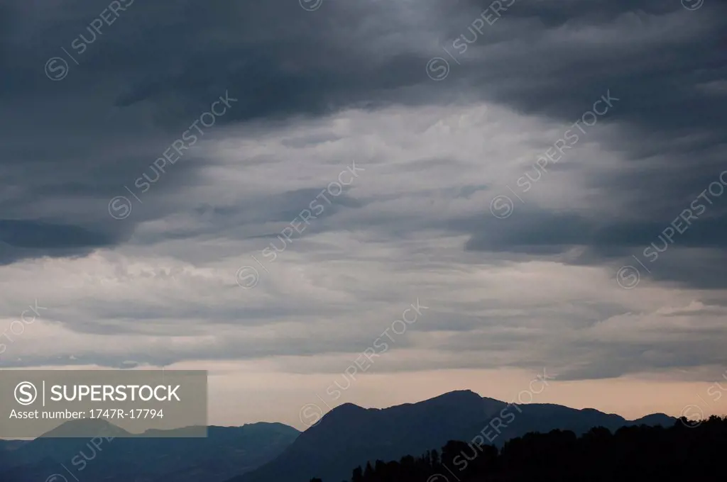 Storm clouds over mountain landscape