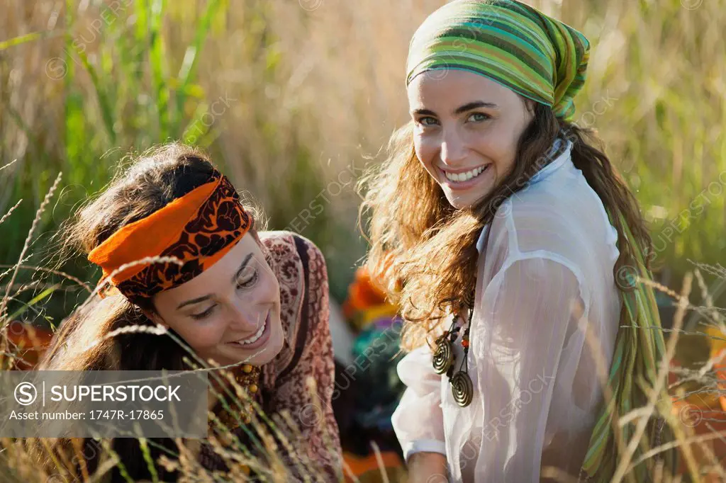 Young women reclining in grass together