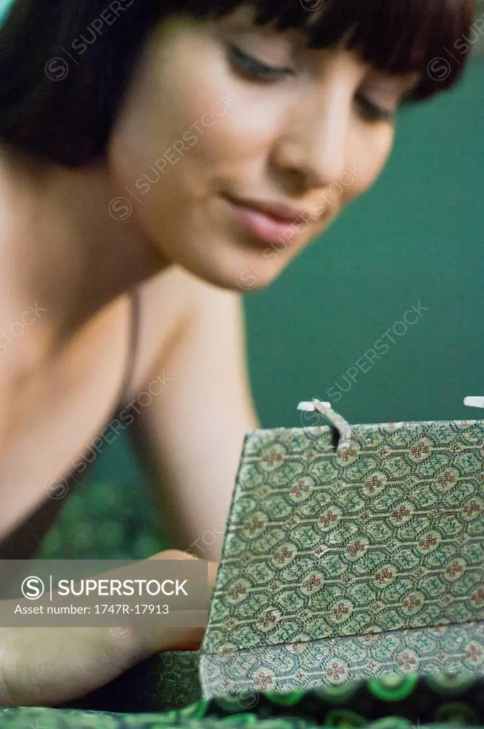Woman contemplating contents of small box