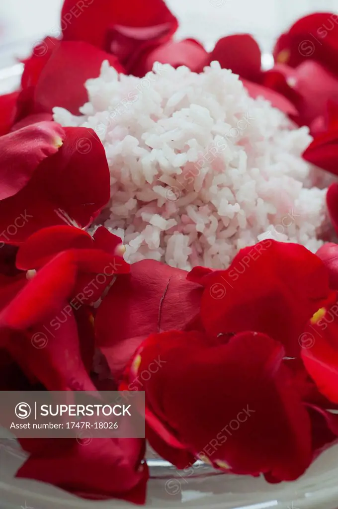 Cooked rice decorated with red rose petals