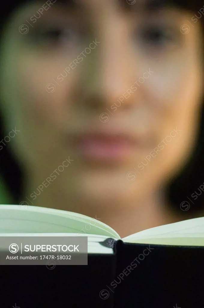 Woman reading, focus on book