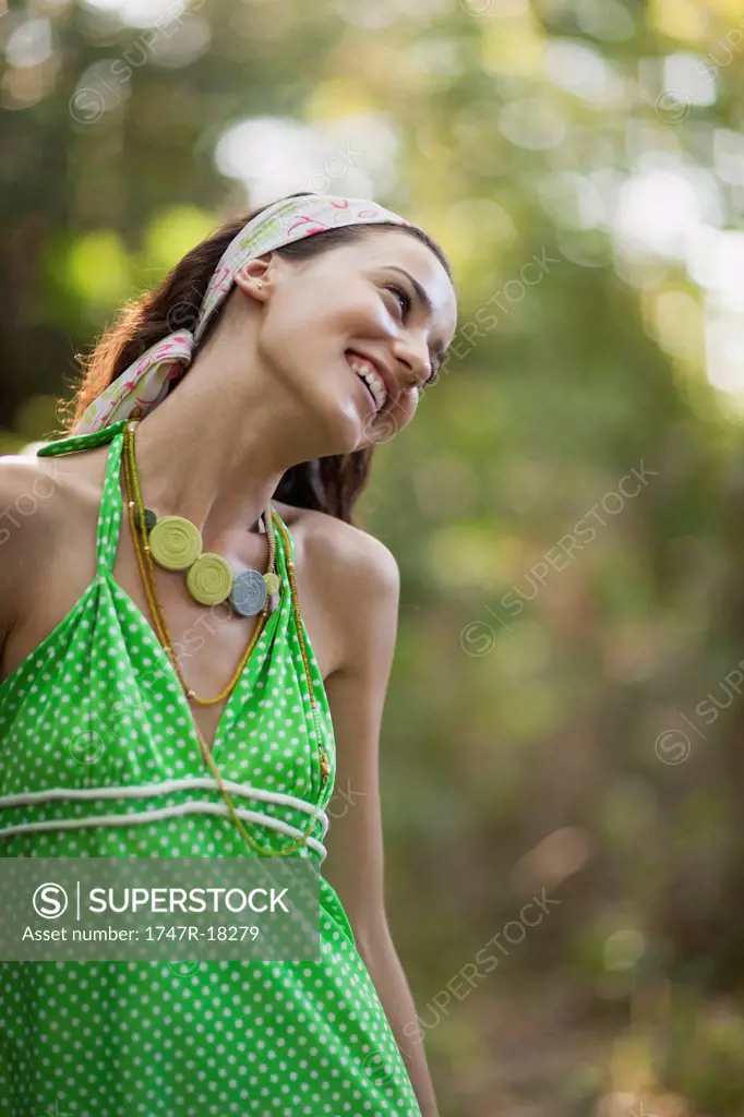 Young woman in halter top outdoors, smiling
