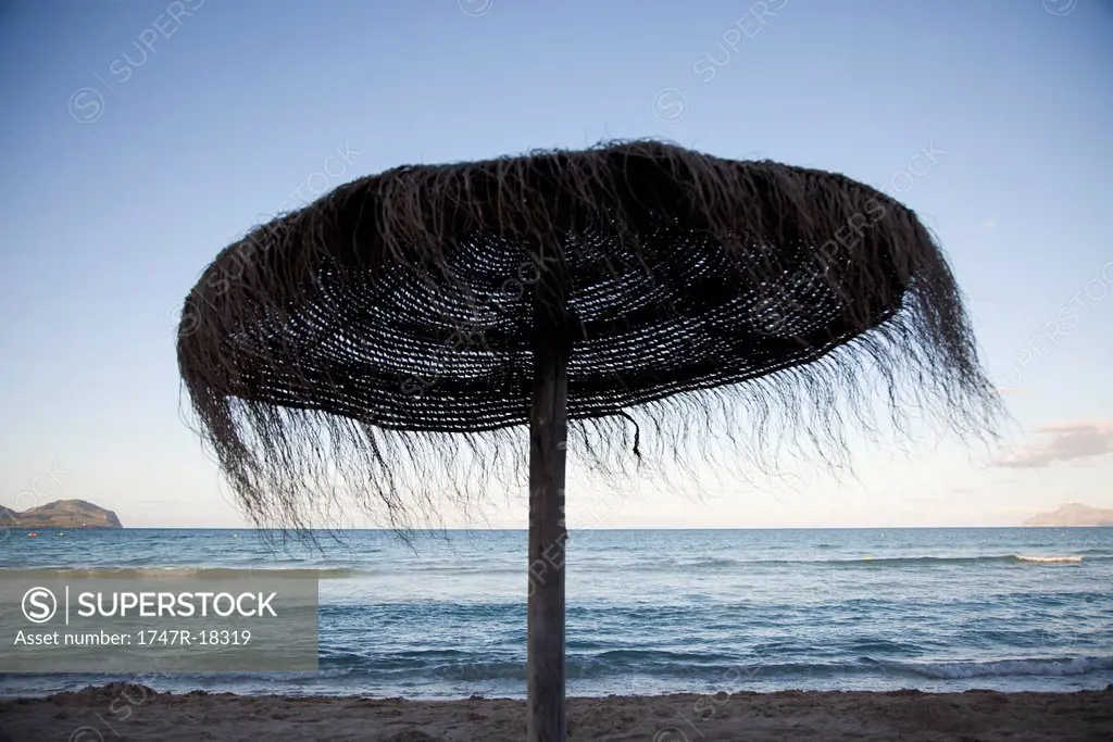 Woven straw beach umbrella