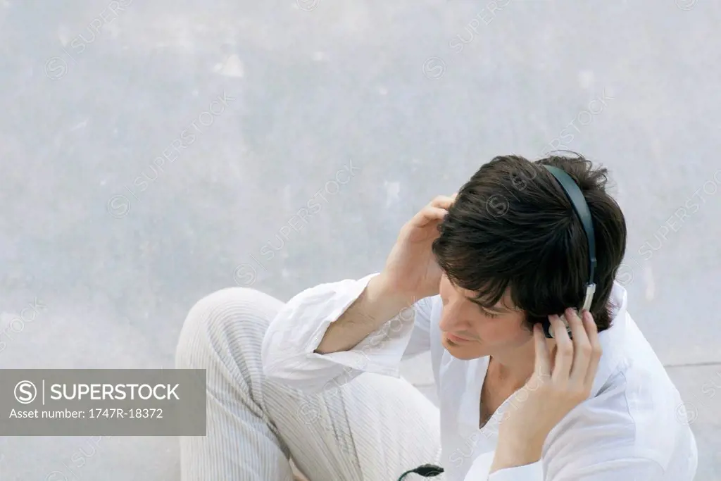 Young man listening to headphones