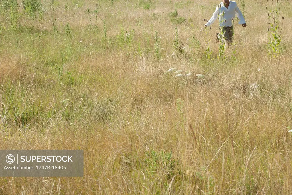 Man running through field, mid section