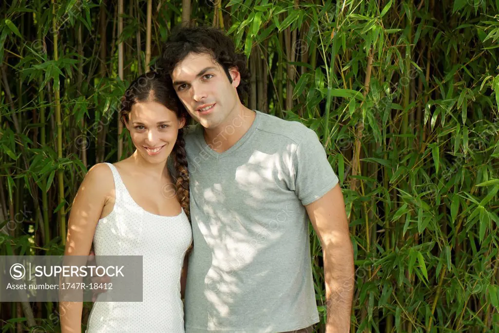 Young couple together outdoors, portrait