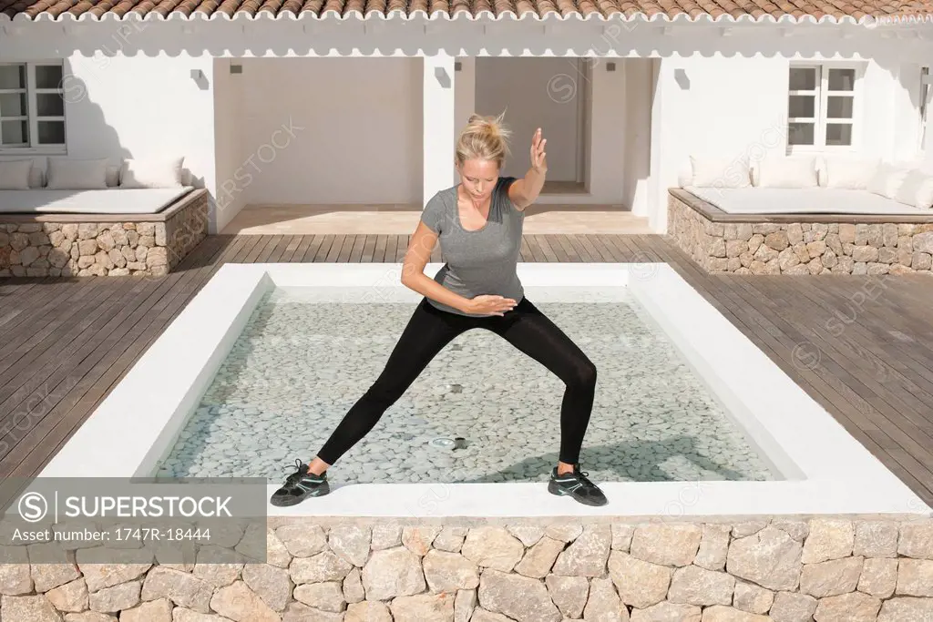 Young woman exercising in patio