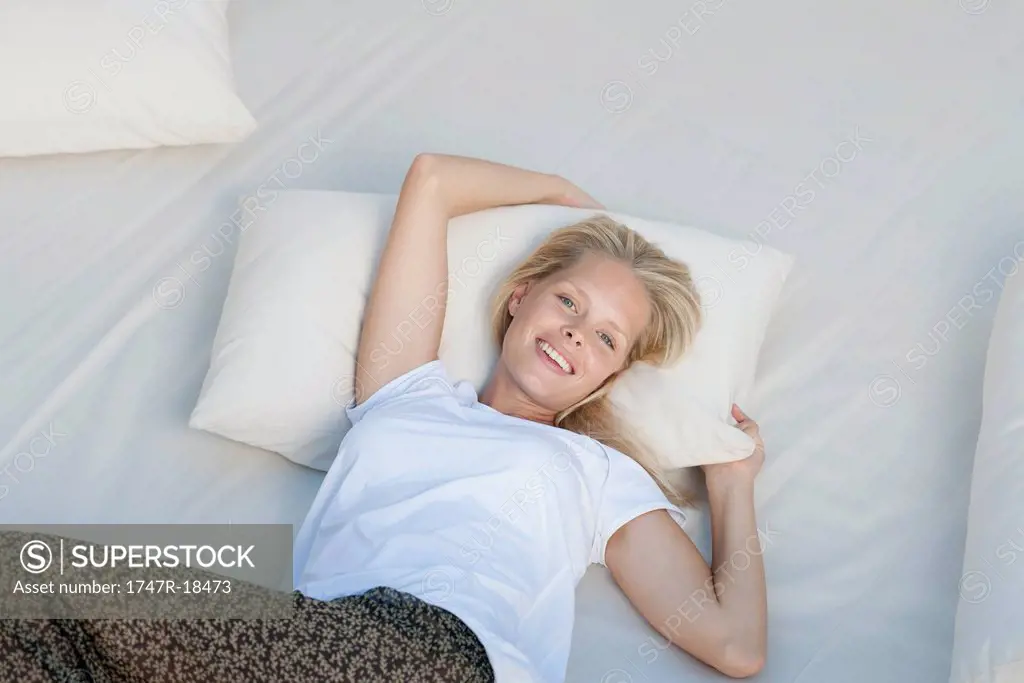 Young woman relaxing on bed