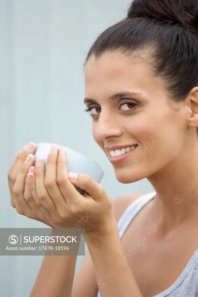 Mid_adult woman holding bowl in cupped hands