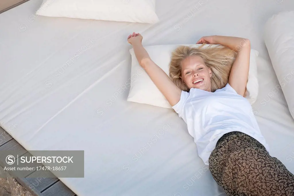 Young woman relaxing on bed