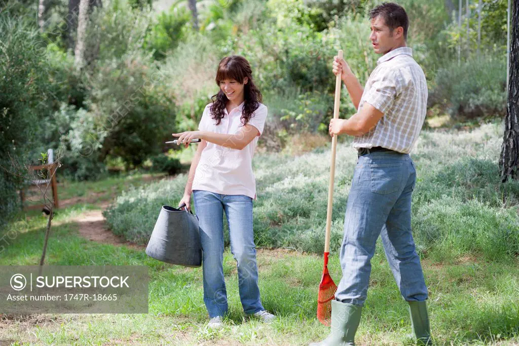 Father and daughter working together in garden