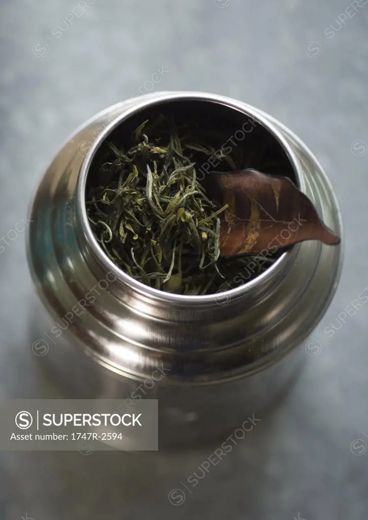 Loose tea leaves in container, high angle view