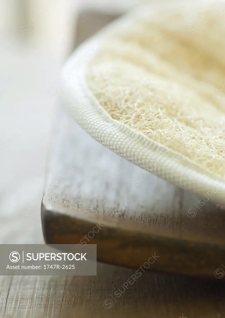Loofah sponge on wooden tray