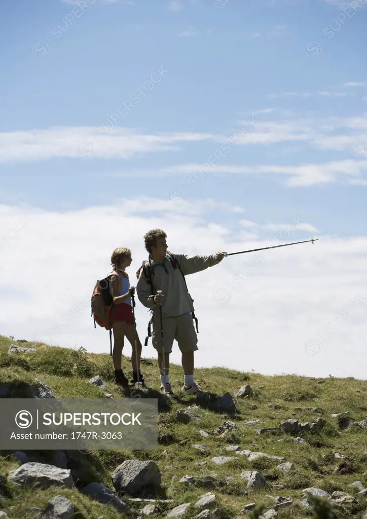 Hikers, man pointing with walking stick