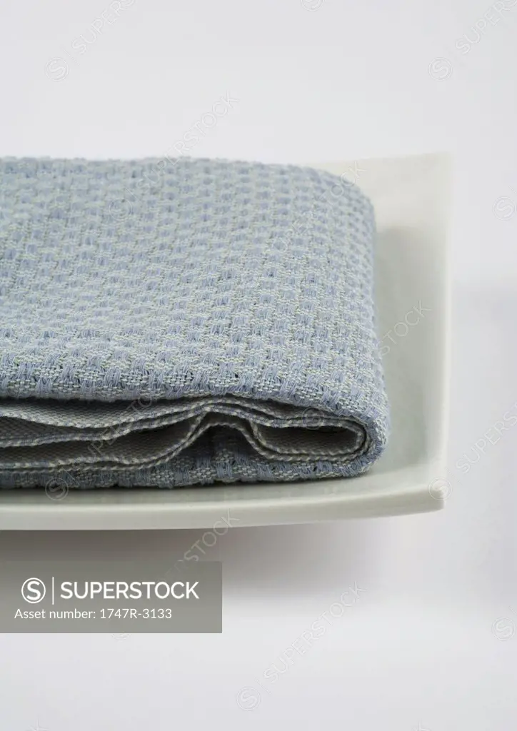 Towel folded on square dish