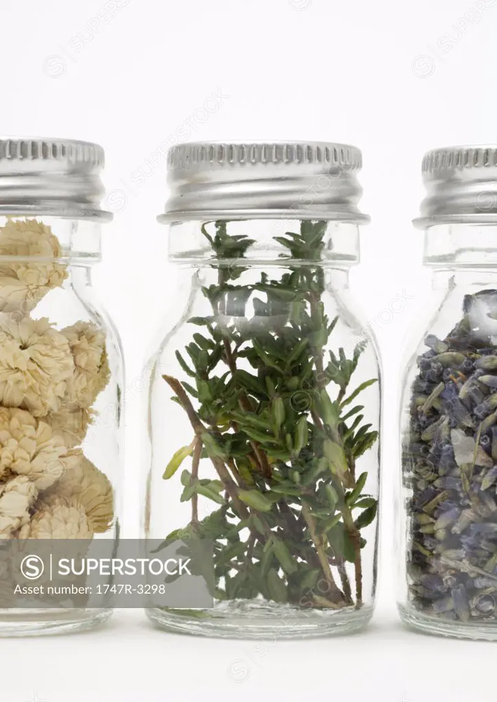 Vials containing herbs and dried flowers