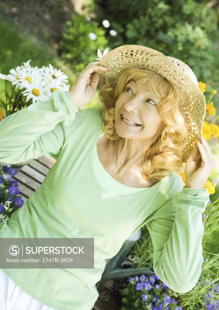 Senior woman wearing straw hat, portrait