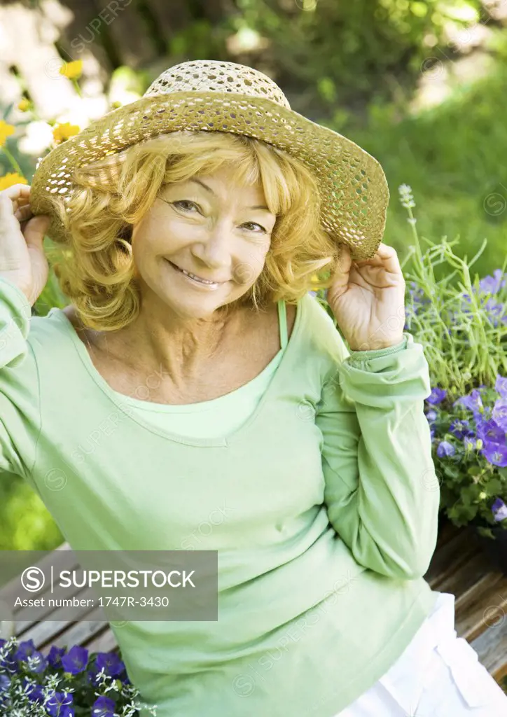 Senior woman wearing straw hat, portrait