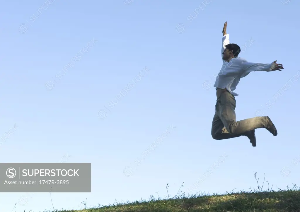 Man jumping in the air, arms out