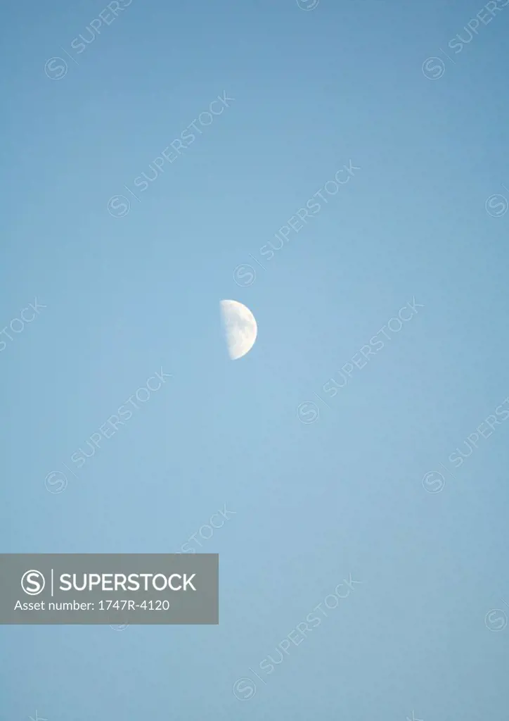 Half moon in blue sky