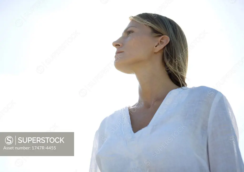 Woman, looking away, low angle view, portrait