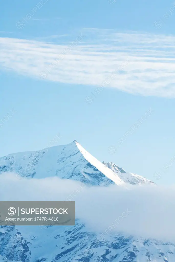 Switzerland, clouds moving over snowy mountains