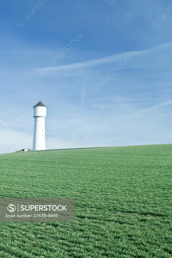 Tower in green field