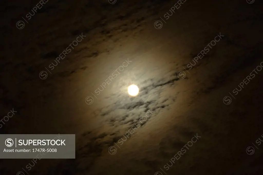 Moon in cloudy night sky