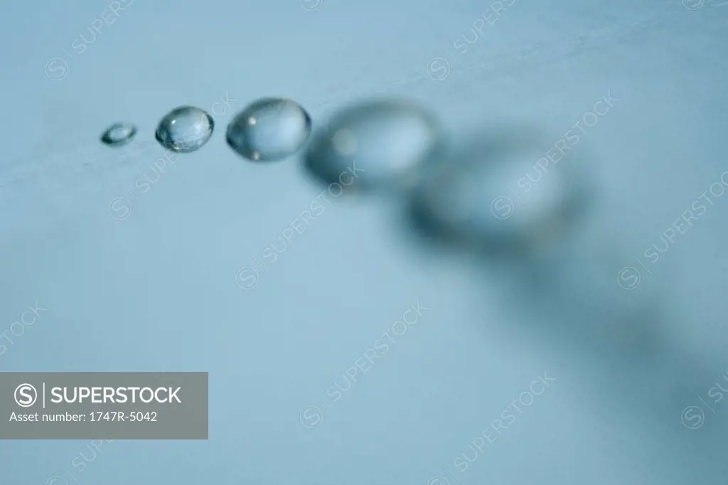 Drops of water arranged in curve, close-up
