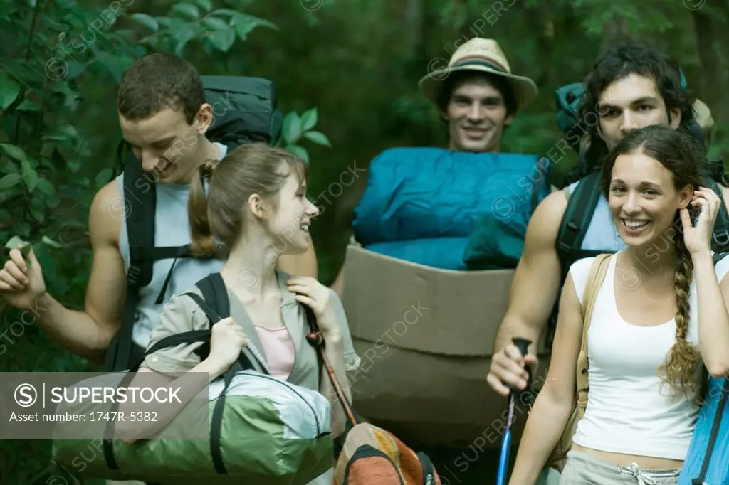 Group of wilderness campers carrying equipment