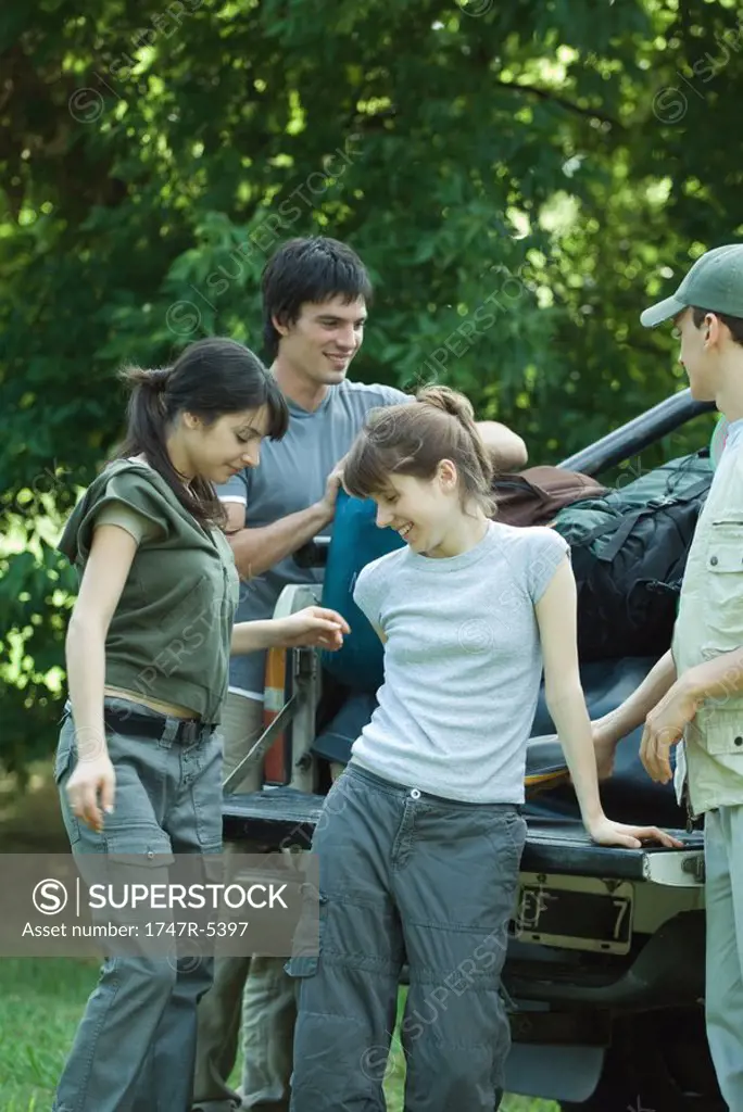 Group of hikers standing by back of pick-up truck