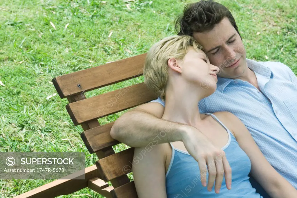 Couple reclining on lounge chair together